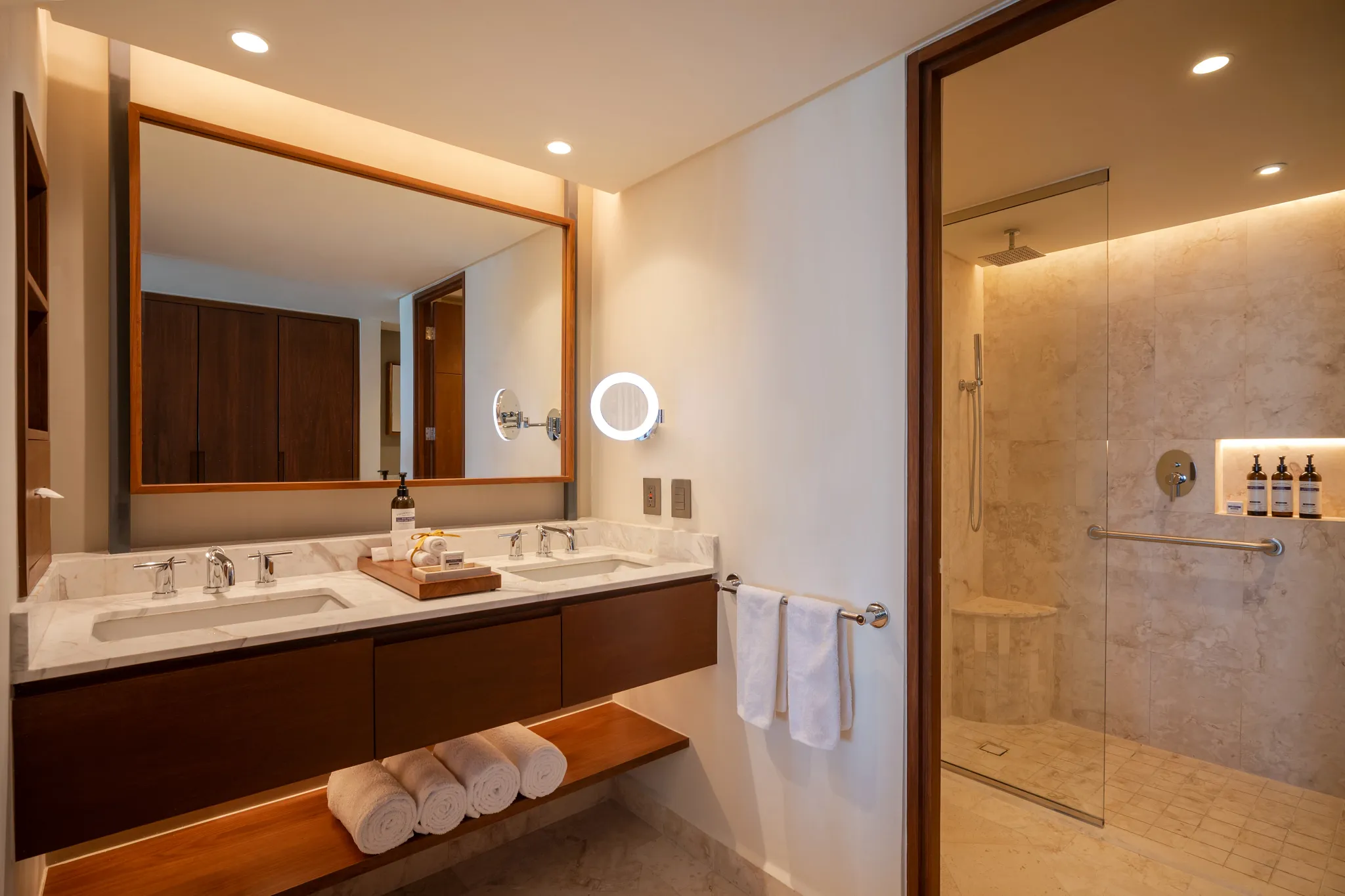 Deluxe Ocean View Balcony bathroom with double vanity and walk-in rain shower at Secrets Mirabel Cancun Resort & Spa.