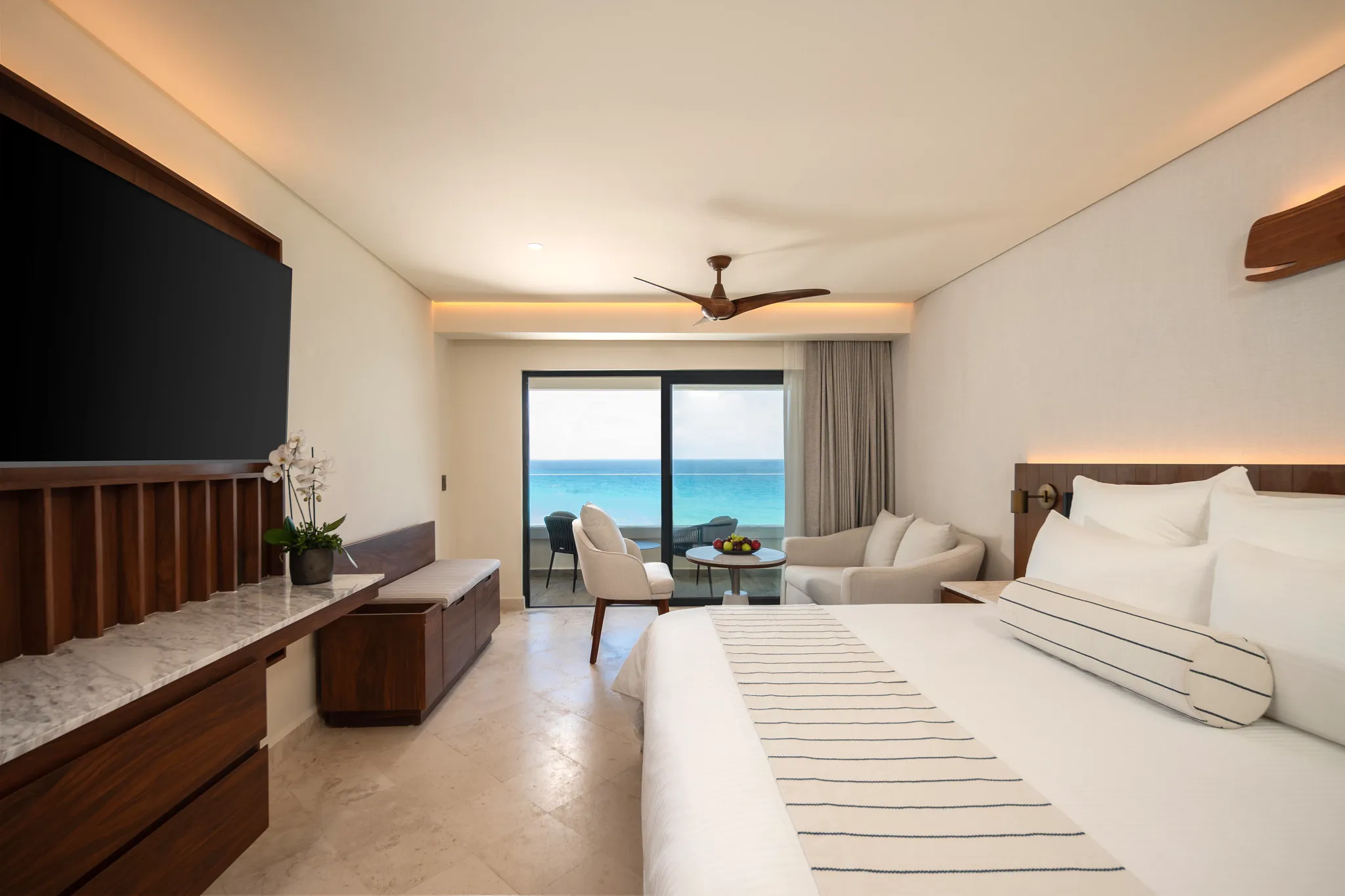 Deluxe Ocean View Balcony king room with furnished balcony overlooking the Caribbean Sea at Secrets Mirabel Cancun Resort & Spa.