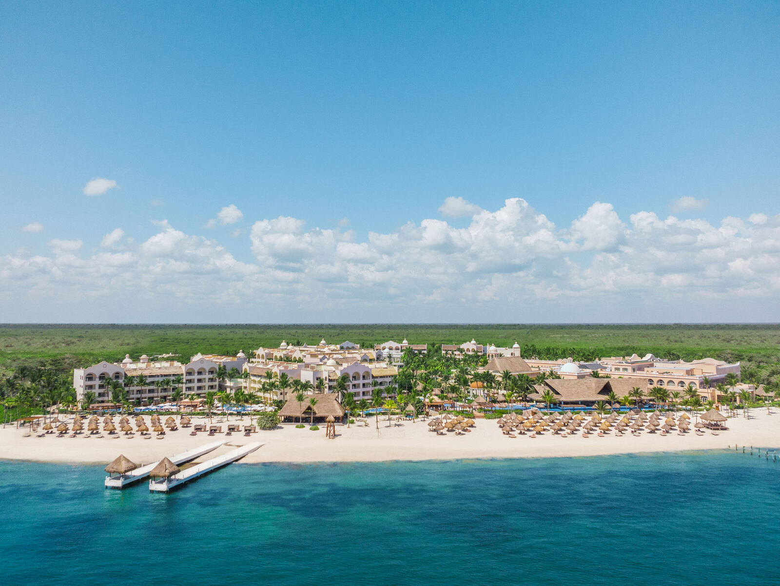 Excellence Riviera Cancun adults-only all-inclusive resort with beachfront pools, swim-up suites, and tropical gardens in Puerto Morelos.