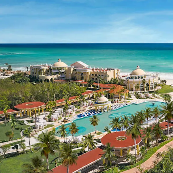 Iberostar Grand Paraiso adults-only all-inclusive resort in Riviera Maya with colonial architecture, beachfront setting, and lush tropical gardens.