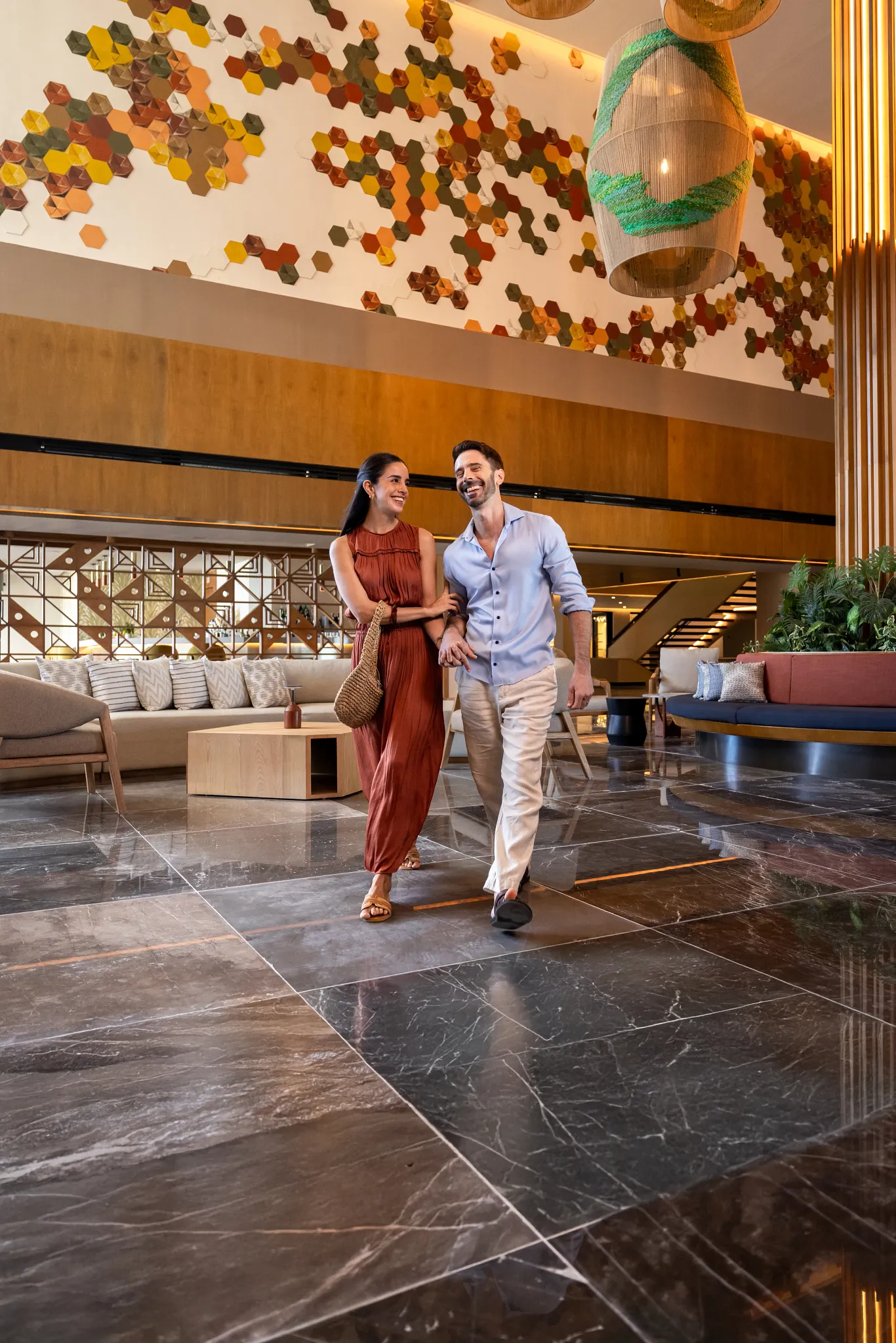 Couple walking through the luxurious lobby at Secrets Mirabel Cancun Resort & Spa in Cancun.