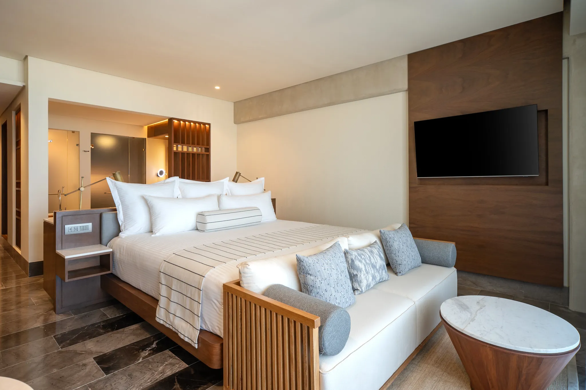 Modern king bedroom inside the Penthouse Presidential Plus One Junior Suite at Secrets Mirabel Cancun Resort & Spa.