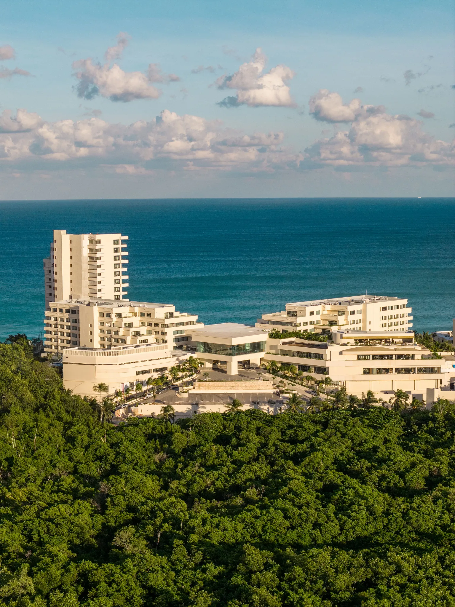 Aerial view of Secrets Mirabel Cancun Resort & Spa surrounded by lush greenery and ocean views in Cancun.