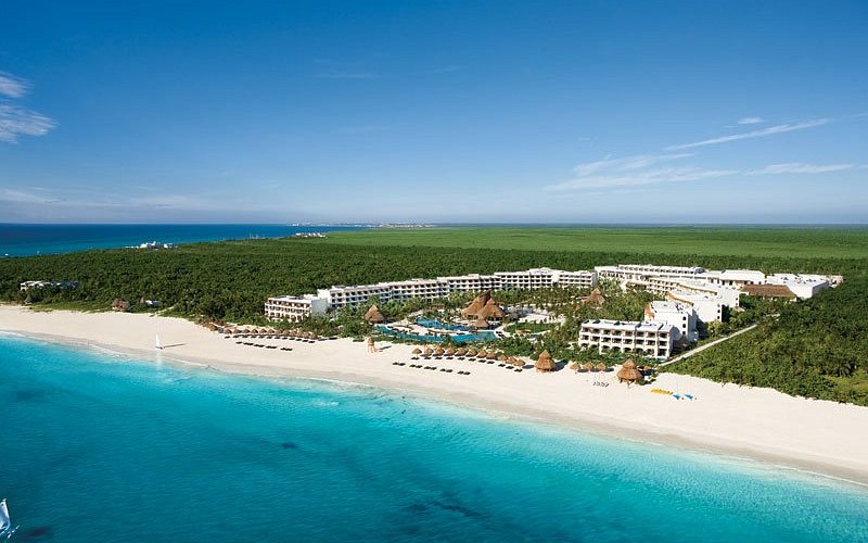 Secrets Maroma Beach Riviera Cancun adults-only all-inclusive resort with pristine white sand beach, turquoise waters, and lush tropical setting.